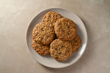 Oat cookies with peanut butter and chocolate chips in a plate. Top view