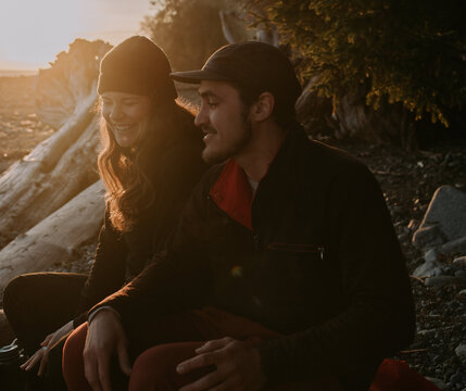 Outdoor couple laugh at the beach