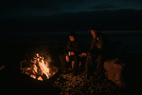 Sitting around the campfire at the beach 