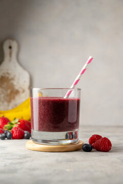Glass of berry smoothie in a glass. Strawberry, banana, blueberry healthy drink. 