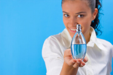 young pretty girl holding perfume