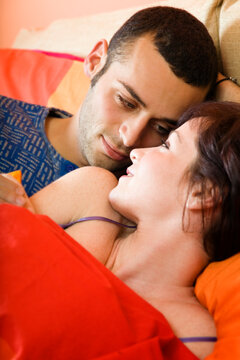 nice young couple laying on the bed
