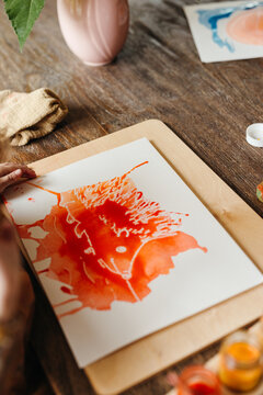 Overhead view of blow painting of a hedgehog using  watercolors