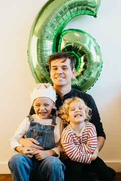 Father with his son and daughter on birthday party