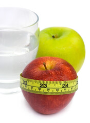 Glass with Water, Green and Red Apple with measuring tape