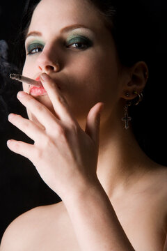 a beautifull girl smoking a cigarette