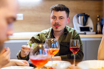 Close-up shot of a young male at home hosting a wine tasting