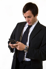 Handsome brunette young business man wearing business suit with blue tie text messaging