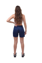 rear view of a young girl standing and arms akimbo on white background