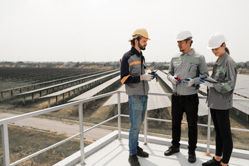 Engineers inspecting construction of solar panel at roof top. solar farm with an energy storage...