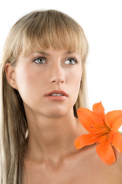 fresh and beautiful portrait of a woman with an orange lily