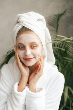 Content Woman With Closed Eyes Applying Facial Mask