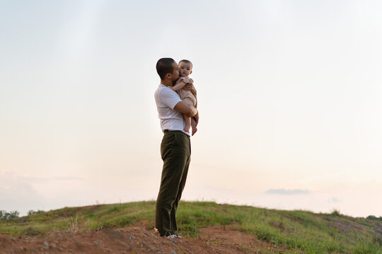 father kissing child