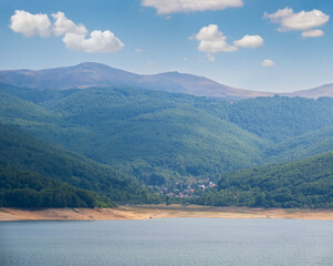 Mavrovo Lake summer countryside landscape with mountains background. Mavrovi Anovi village, North Macedonia, Europe.