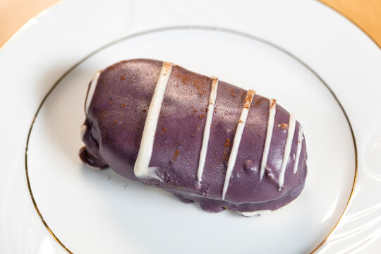 Cake with berry filling and decoration. delicious close-up blackberry inserts. Purple cake on a porcelain plate.