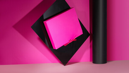 Mockup of a pink box with a bow in volume for design	
