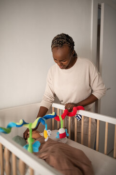 Black mother taking care of newborn baby