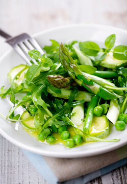 asparagus,rocket,beans,peas,zucchini,spring onions, basil, covered in olive oil