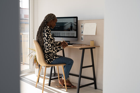 Black female journalist writing down ideas