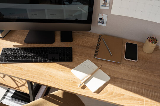 Modern workplace with computer on sunny day