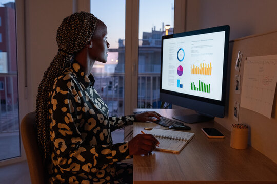 Black accountant working with diagrams on computer