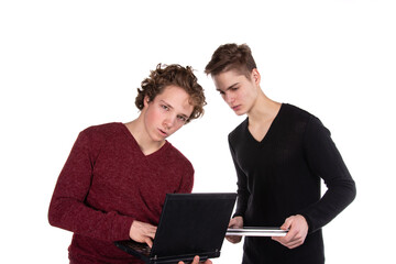 Two young attractive students with a laptop.	