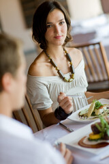 A young woman eating lunch at a restaurant