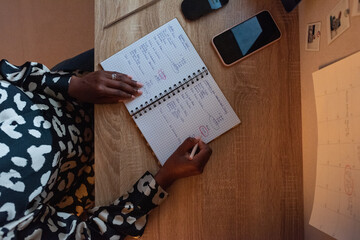 Crop black businesswoman working on project