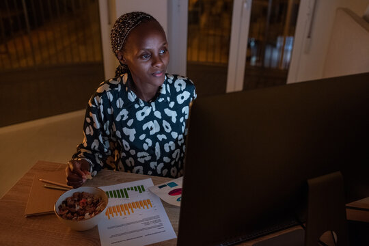 Smiling black businesswoman working on startup project