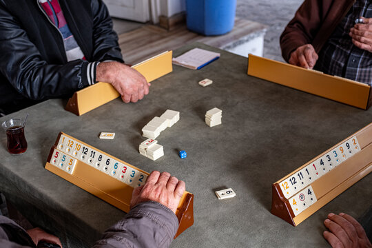 group of anonymous elderly man playing a board game