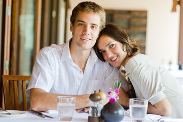 A young couple sitting together in a restaurant