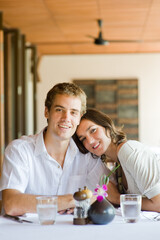 A young couple sitting together in a restaurant