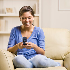 Teenage girl text messaging on cell phone