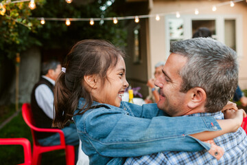 Father and daughter embraced at garden portrait