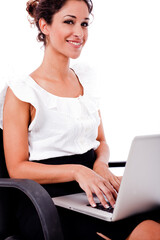 Portrait of a woman working with laptop by sitting in the wheel chair