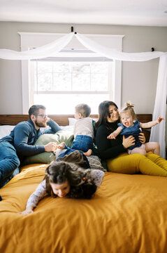 Happy family on big bed together