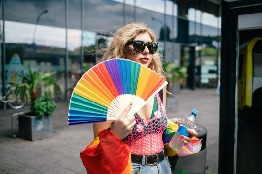 Woman with curly blond hair and sunglasses going to Pride