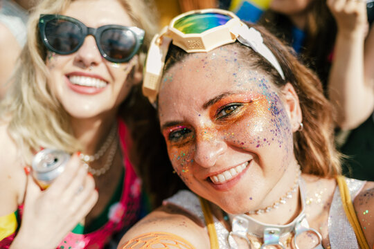 Two Women Having Fun in Colorful Clothes and Bright Makeup at Pride