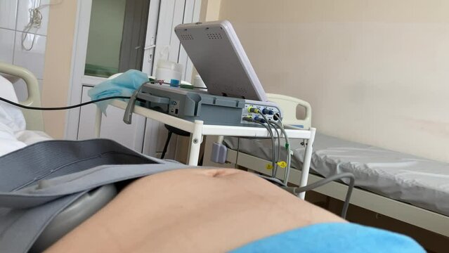 Cardiotocography. Pregnant Woman On Hospital Couch During Medical Control Cardiotocography.