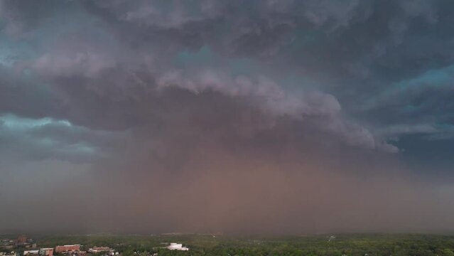 Drone timelapse of large storm creating a dust cloud underneath, rolling in over Iowa City, Iowa.