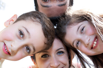 Closeup portrait of a happy family in circle against a white background