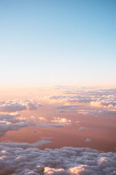 Clouds at sunset out of the plane window