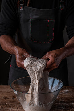 Baker kneading a dough to make bread
