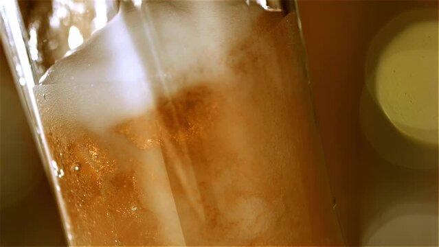 Craft IPA microbrewery:  a Liquid Symphony in high-speed 4K. Refreshing craft IPA beer poured into a glass in stunning slow-motion. Witness the artistry of brewery craftsmanship&mdash;Froth cold beer. 
