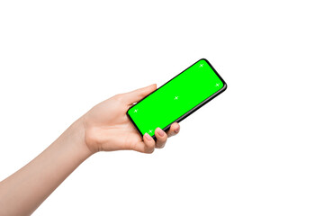 Isolate of a female hand with a smartphone. Green screen on device screen, easy to insert your ads.