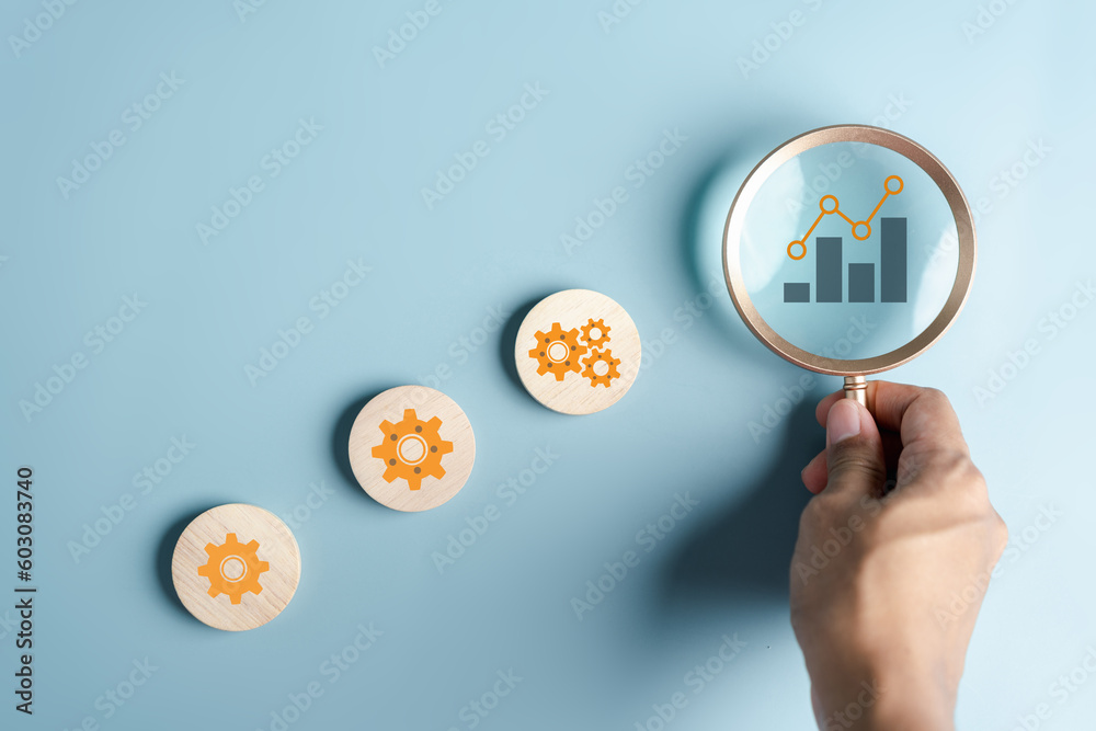 Aufkleber hand holding magnifier to analysis portfolio management, steps planning for development and business