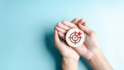 Hands hold aiming target objective icon for planning development leadership and customer target...