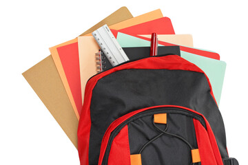 A black and red backpack with school material over a white background. Path included