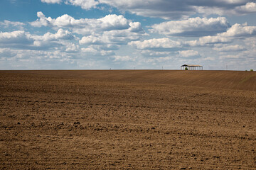 Plowed field before sowing on a sunny day.