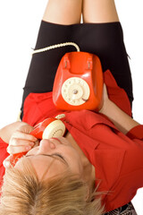 Top view of a woman chatting on a vintage red telephone - isolated